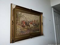 Image showing the painting in the ornate frame hung on a wall, capturing the overall scene and frame details.