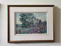 Full view of framed oil or acrylic landscape painting depicting cottage and pink flowers by James Keirstead.