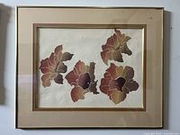 Framed Mid-Century Modern Canadian leaf abstract art with textured leaf details and autumn tones, including the entire frame and matting.