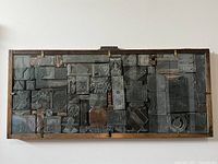 Straight-on shot of full framed collage showing arrangement of metal blocks