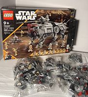 Photo showing Lego Star Wars set 75337 box, multiple sealed plastic bags containing Lego pieces laid out, indicating near complete or complete set.