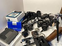 Overview of all items: Polaroid Spectra box, SLR, P&S camera, binoculars, light meter and lenses