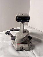 Front view of Nintendo Robotic Operating Buddy showing head unit, column, base and both arm attachments