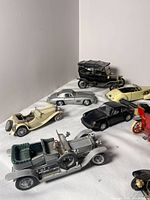 Wide view of 10 vintage toy cars showing various classic designs, colors, and roof types