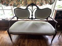 Full front view of the loveseat showing frame and upholstery