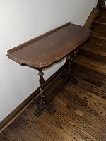 Full view of the antique solid walnut library trestle side table, showing the carved legs and trestle base design.