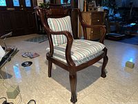 Side view of the Victorian mahogany elbow chair showing arm detail, seat and leg design.