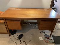 Front view of full desk showing drawers, drop-front compartment, and leg style