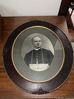 Full view of the antique framed sketch depicting a clerical figure, showing the oval frame and the detailed attire in the sketch.