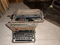 Front view of an antique Underwood typewriter showing keyboard and paper holder.