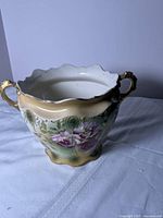 Front angled view of Victorian wash bowl showing floral design and gold handles