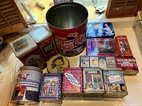 Overview of vintage retro collectible tin can collection, showing variety of brands, shapes, sizes and vintage artwork.