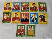 All 12 Topps 1959-60 hockey cards laid out in three rows