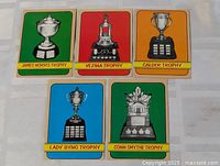 Five 1972-73 OPC trophy cards laid out face up