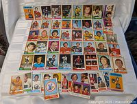Spread of roughly 50 cards laid out showing variety of 1974-75 O-Pee-Chee fronts