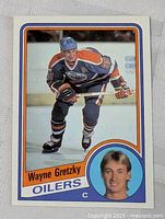 Front view of 1984-85 Topps Wayne Gretzky card showing action photo, headshot, Oilers text