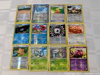 All 12 holographic cards laid out in four rows of three