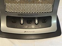 Close-up of control panel on Bionaire heater with switches and indicator light visible.
