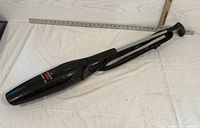Full view of Bissell Magic Vac handheld vacuum cleaner with a measuring stick showing about 40 inches long.