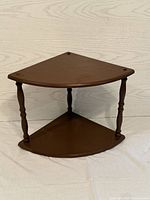 Front view of the two-tier corner wooden trinket shelf showing its compact size and design.