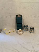 Full view of all items showing the complete lot: two tins, mama and babies figurine, small dish, and mail organizer.