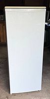 White Kenmore refrigerator front closed view shows clean unmarked finish and rectangular shape.