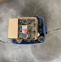 Plastic tub containing a cardboard box with 12 new Bernardin mason jars and several loose mason jars.