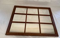 Top-down view of the 9-panel window pane mirror on a light surface.