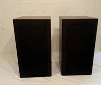 Front view of the pair of Yamaha speakers with black fabric grille covering the drivers.