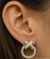 Earring on ear showing size and style of 10K gold and CZ stones