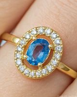 Top view showing oval sapphire and surrounding diamond halo