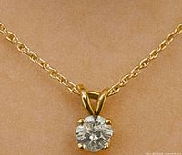 Front view of certified lab diamond pendant showing round brilliant cut diamond set in 14K yellow gold 4-prong setting with bail.