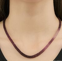 Necklace shown on model bust at neckline for scale