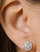 Close-up of moissanite earring worn on ear showing size and design