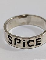 Top view of the silver ring showing "SPiCE" engraving