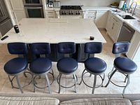 Five stools arranged in front of kitchen island showing full set