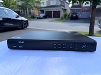 Front view of FLIR DNR408PO NVR showing control buttons and branding.