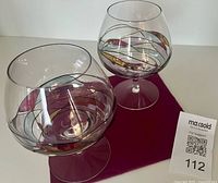 Two stained glass design brandy snifters side by side