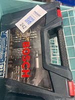 Closed Bosch plastic case with clear window showing bits