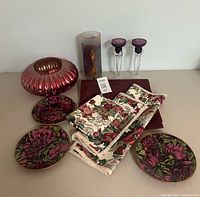 All items grouped showing plates, vases, candle holders, napkins, placemat and runner