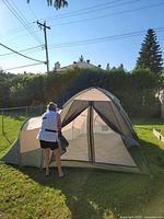 Full view of tent set up with person opening center door