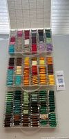 All three clear plastic organizer boxes stacked showing full range of floss colours
