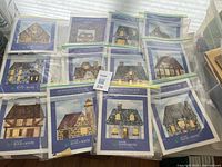 All twelve English Cottage Quilt Block-of-the-Month kits laid out showing pattern sheets and fabric bags