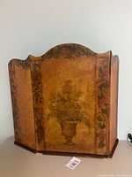 Front view showing urn of flowers design and tri-panel structure