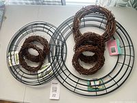 Two metal wreath forms with nested grapevine rings