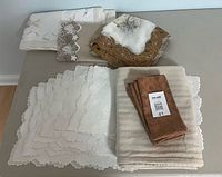 Overview of assorted linens stacked on table