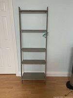 Front view of full ladder shelf showing four shelves