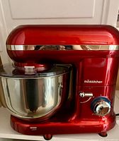 Front view of red ThinkKitchen stand mixer with stainless steel bowl attached