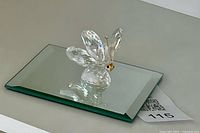 Butterfly figurine positioned on mirror base
