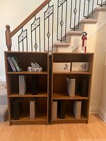 Front view of both oak bookcases under staircase